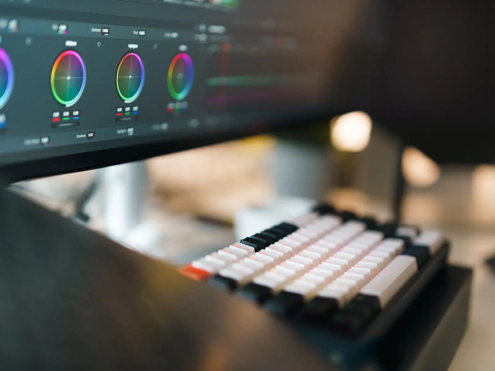 Editing workstation with a timeline open on screen and a dedicated keyboard.