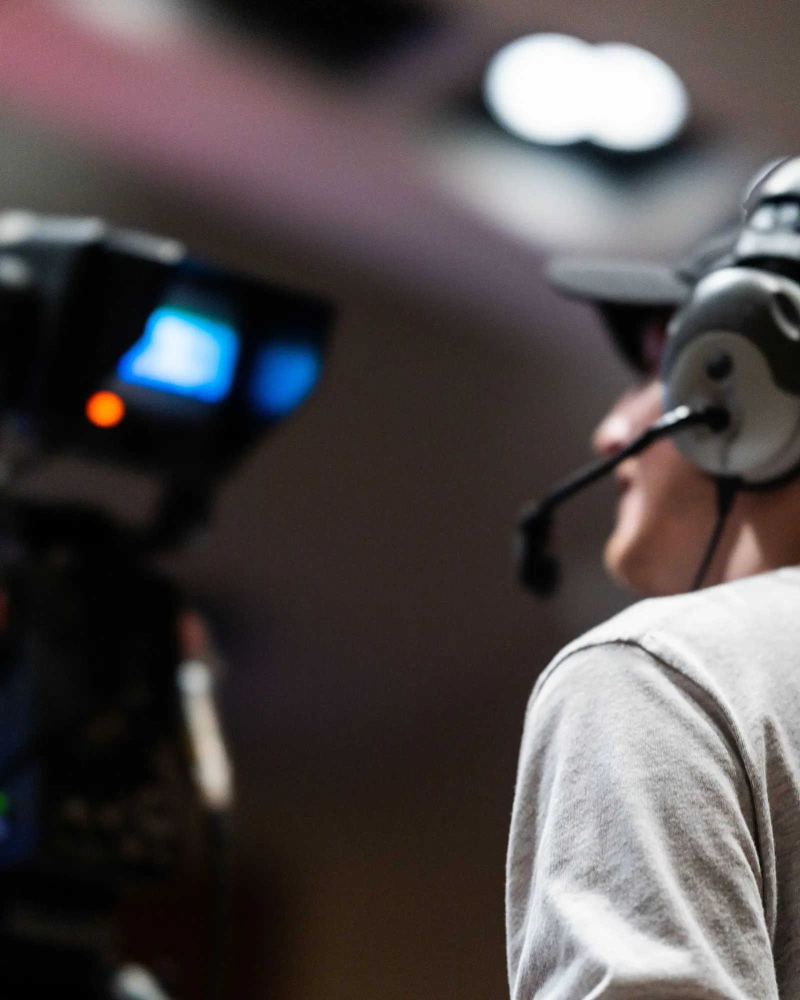 Camera operator on a broadcast camera wearing a comms headset.