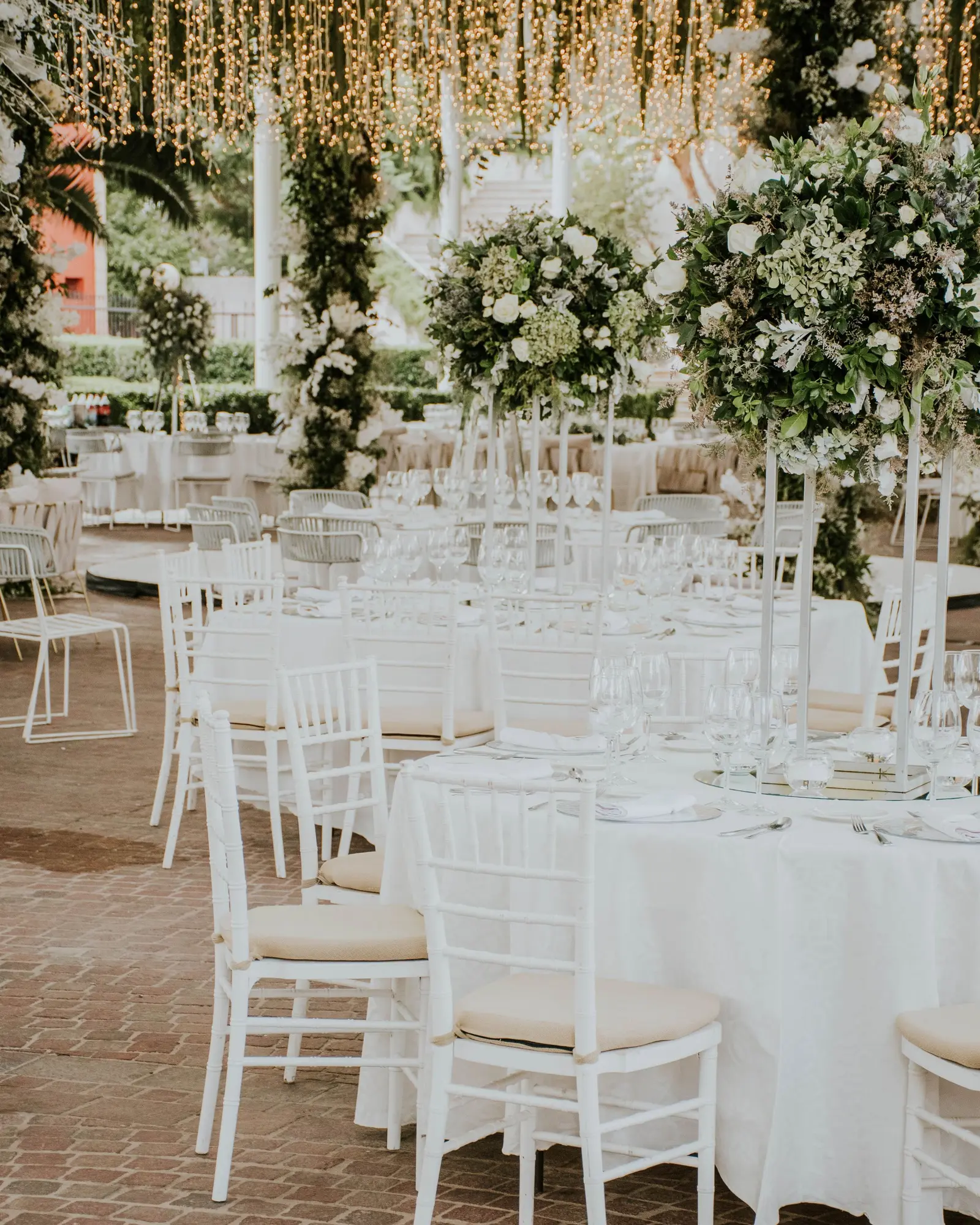 Wedding room dressed in white with draped ceiling and a centred aisle.