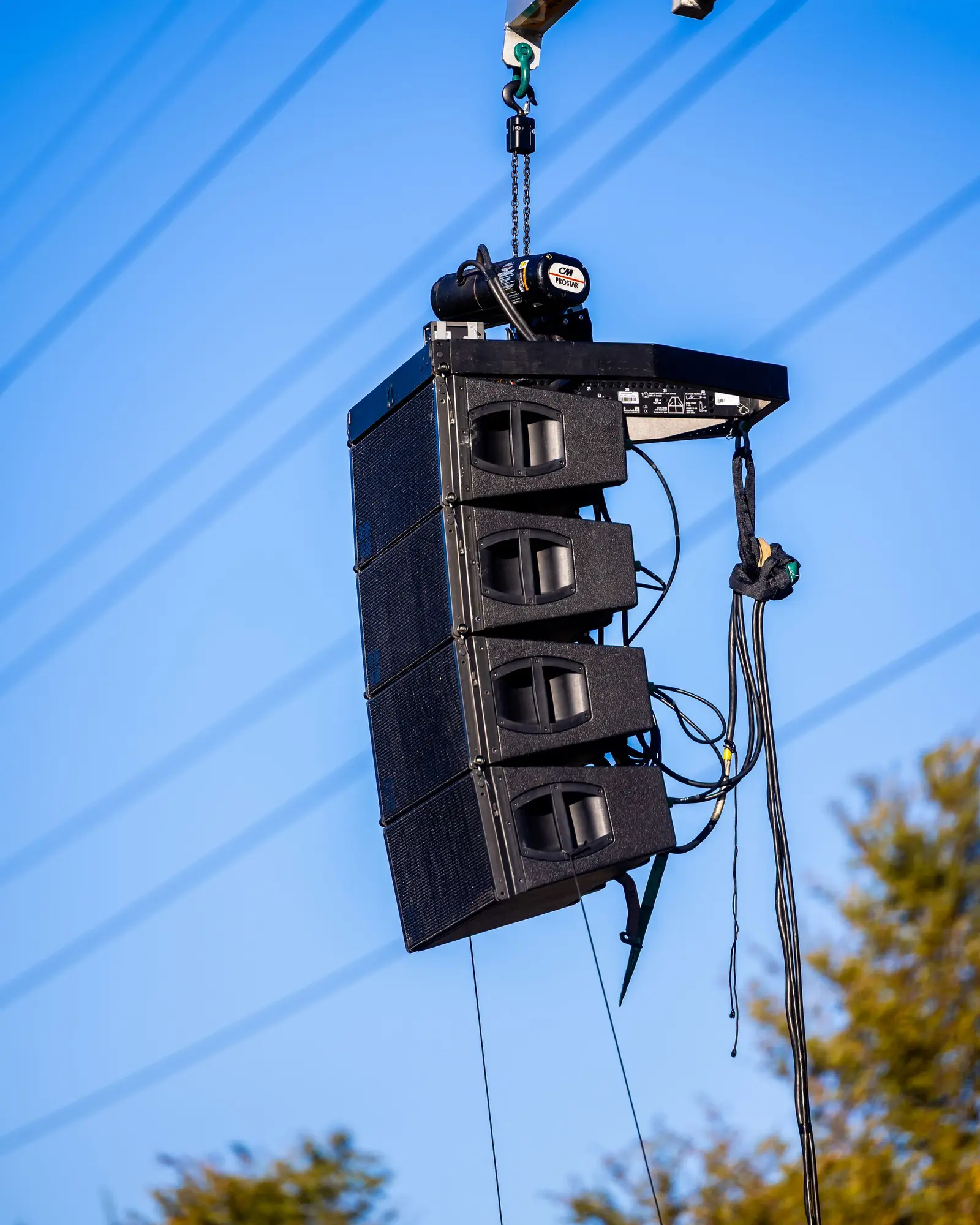 Outdoor speaker stacks and stage system built before an open-air show.